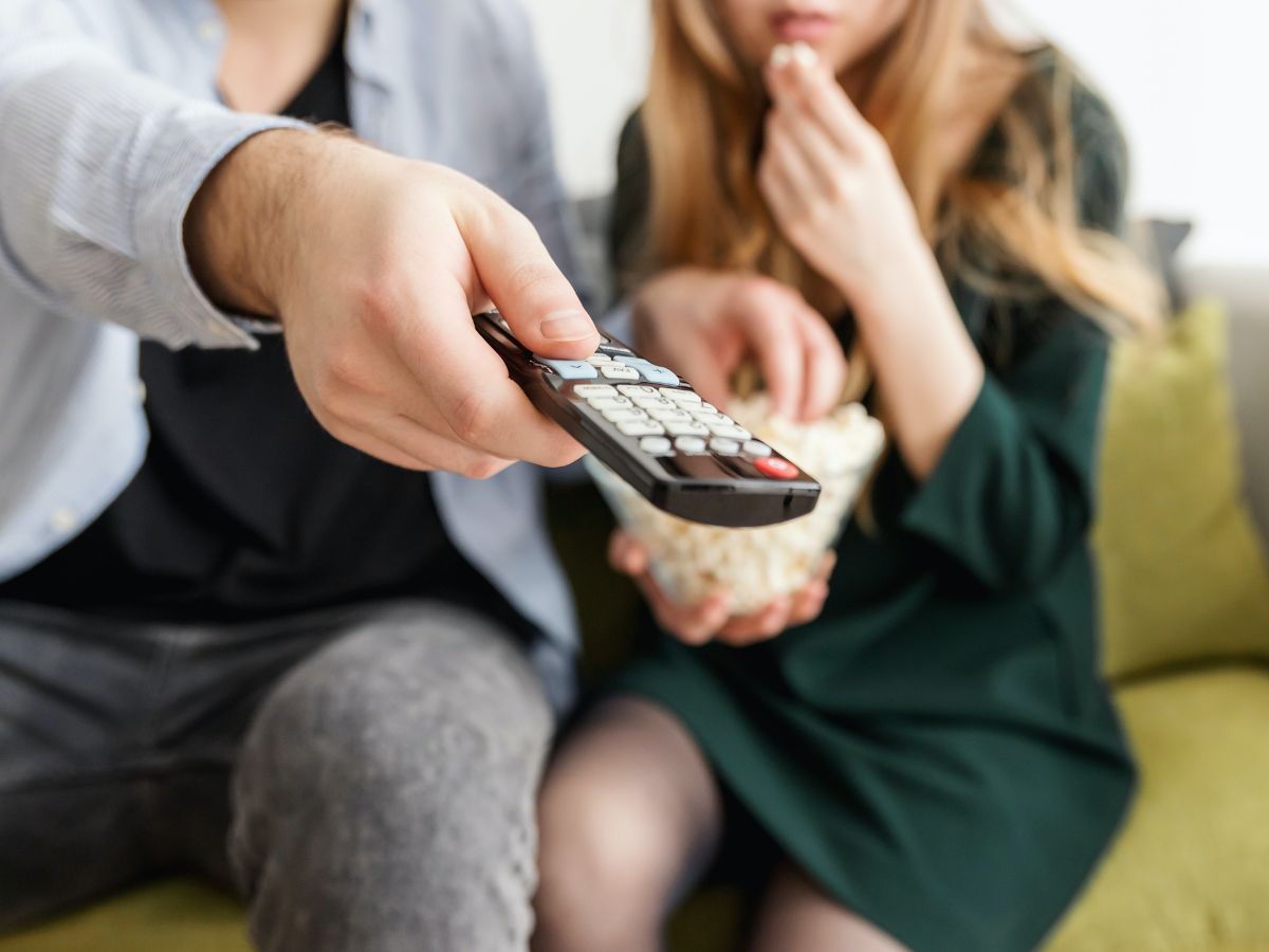 Couple holding a remote control